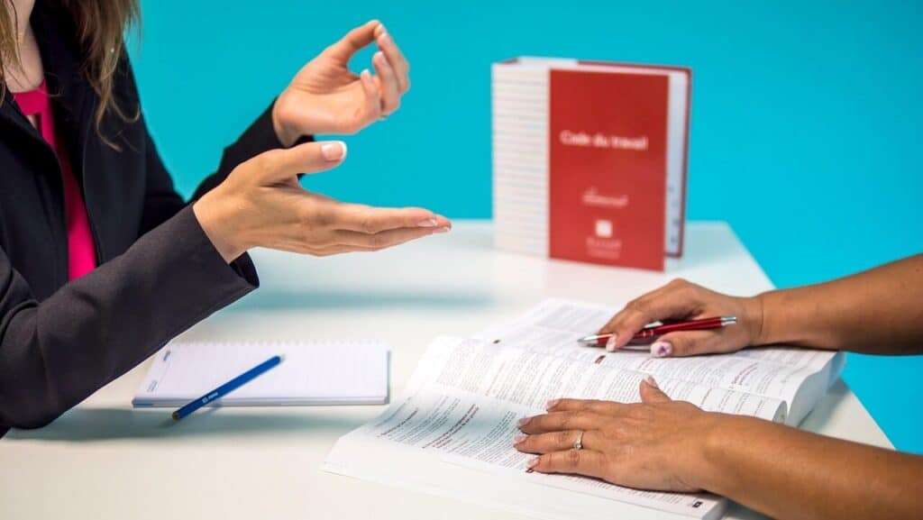 Personas revisando documentos legales sobre incapacidad permanente en España.